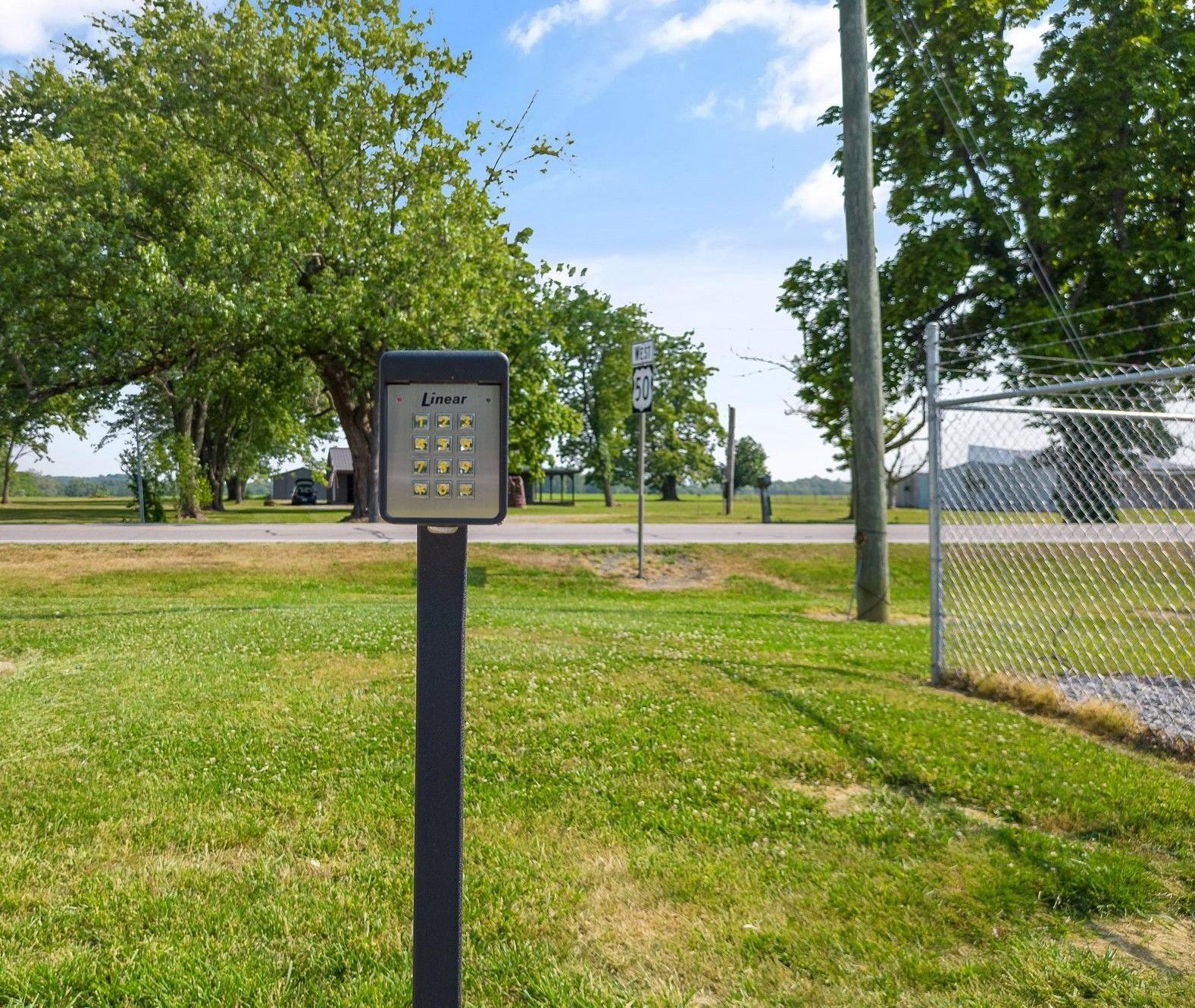 A man and a woman are sitting on the floor in a room filled with cardboard boxes.