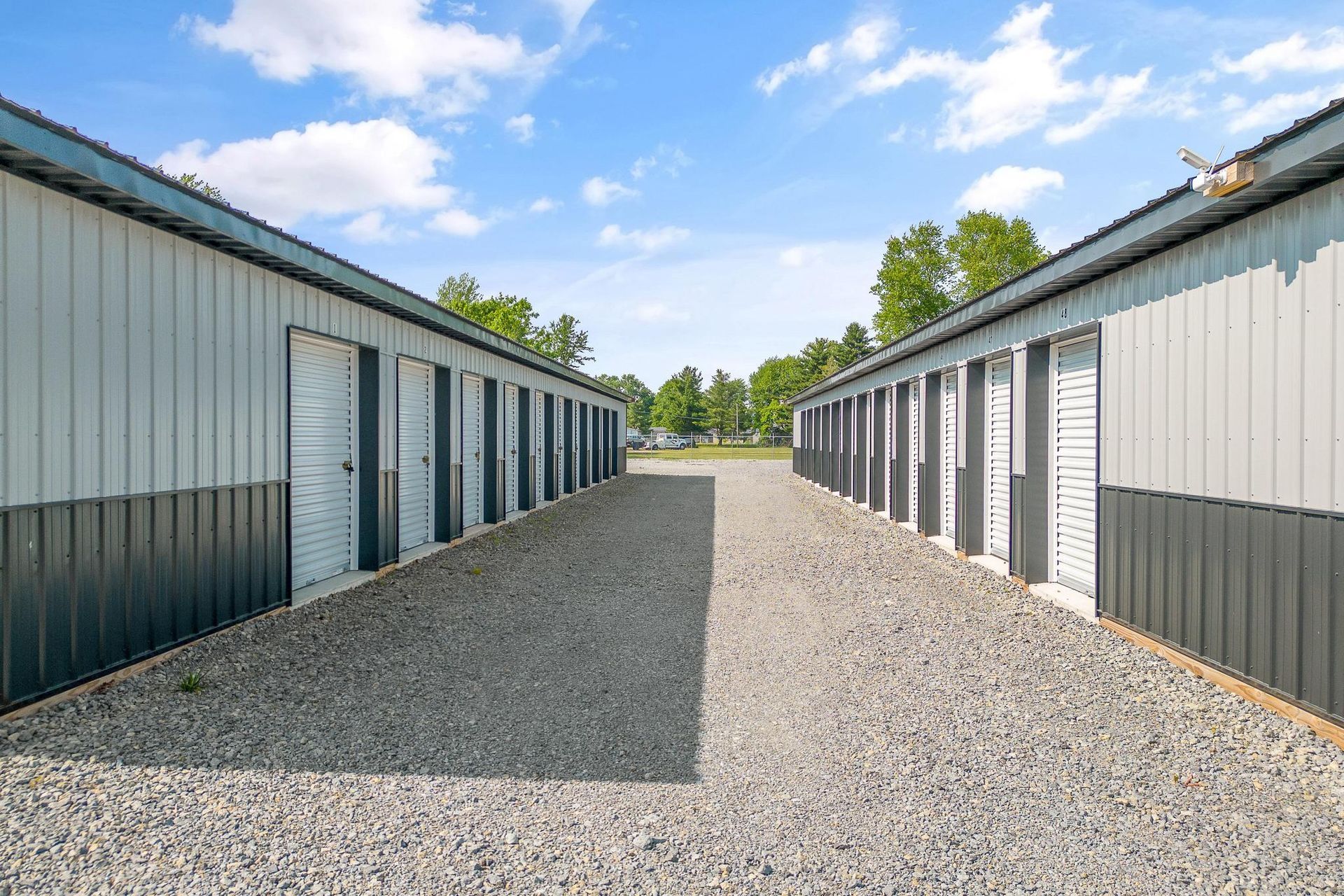 A woman is carrying a stack of cardboard boxes.
