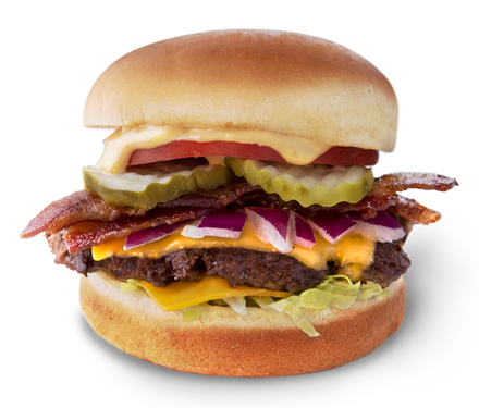 A hamburger with cheese bacon onions and pickles on a bun