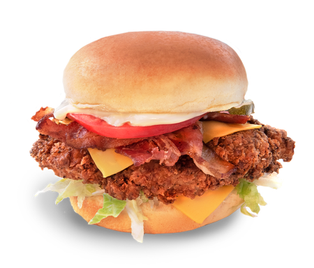 A chicken sandwich with bacon cheese lettuce and tomato on a bun