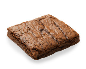 A brownie is sitting on a white surface.