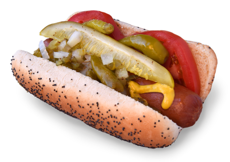 A hot dog with pickles tomatoes onions and mustard