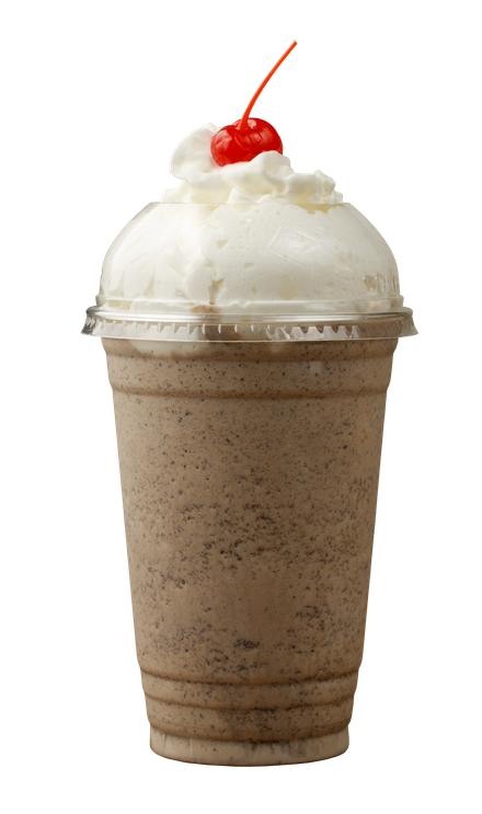 A milkshake with whipped cream and a cherry on top