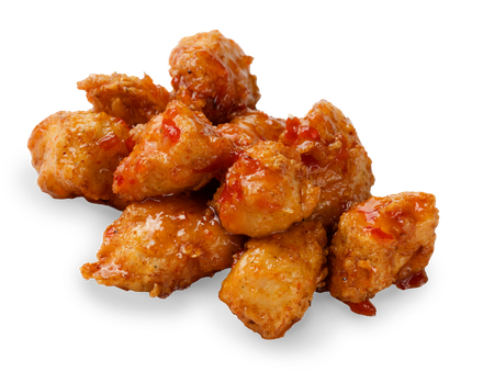 A pile of fried chicken with sauce on a white background