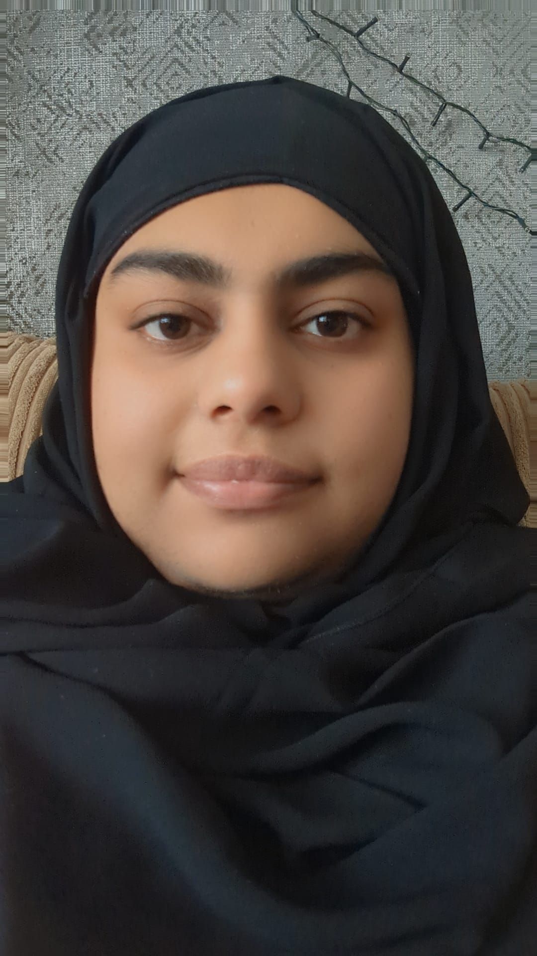 Asian lady smiling wearing a black hijab