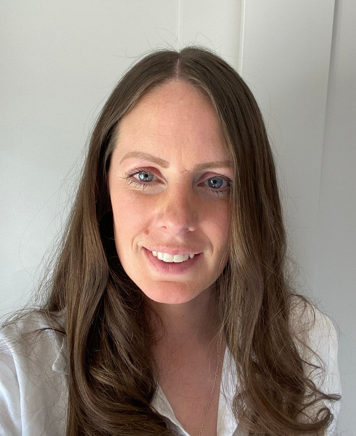Woman long brown hair white top