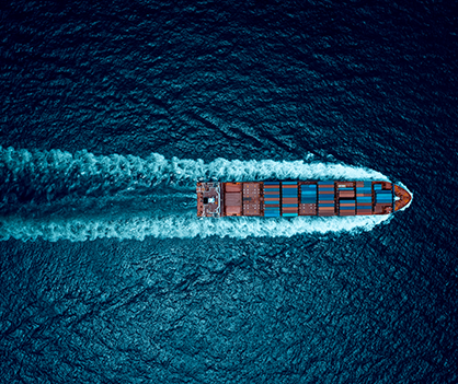 An aerial view of a large container ship in the ocean.