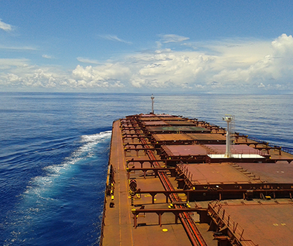 A large ship is floating on top of a large body of water