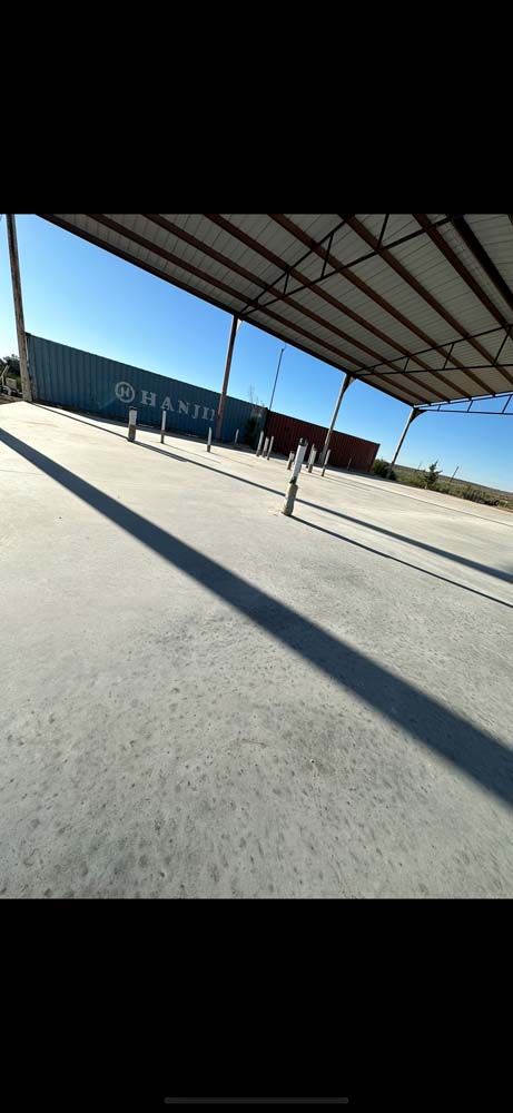 A shadow of a person is cast on the floor of a building.