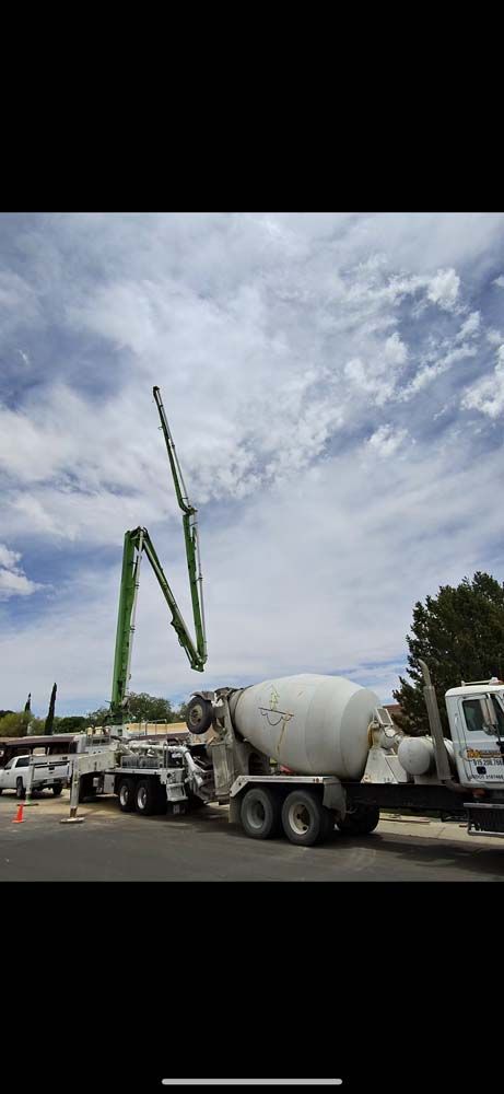 A concrete mixer truck is parked on the side of the road.