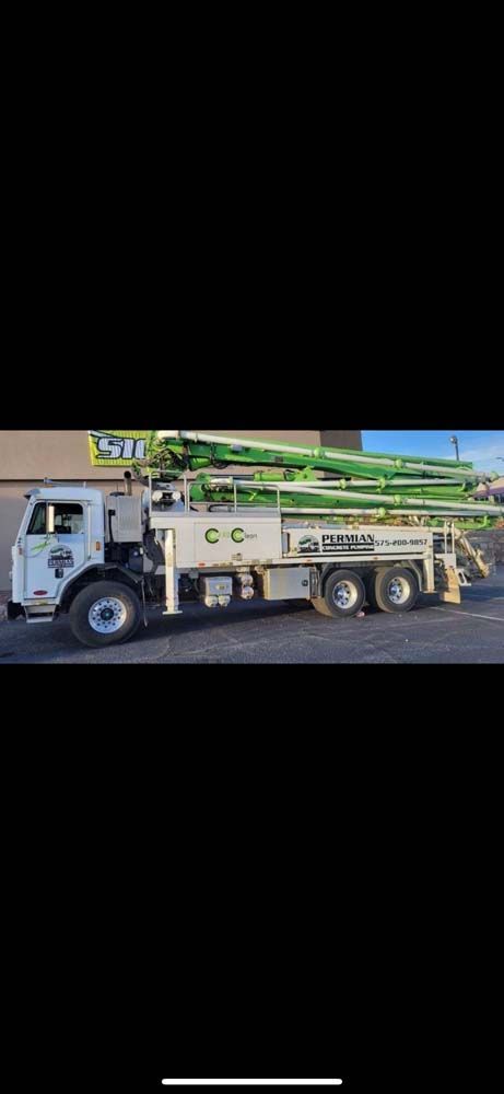 A concrete pump truck is parked in a parking lot.