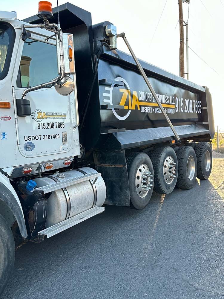 A dump truck is parked on the side of the road.