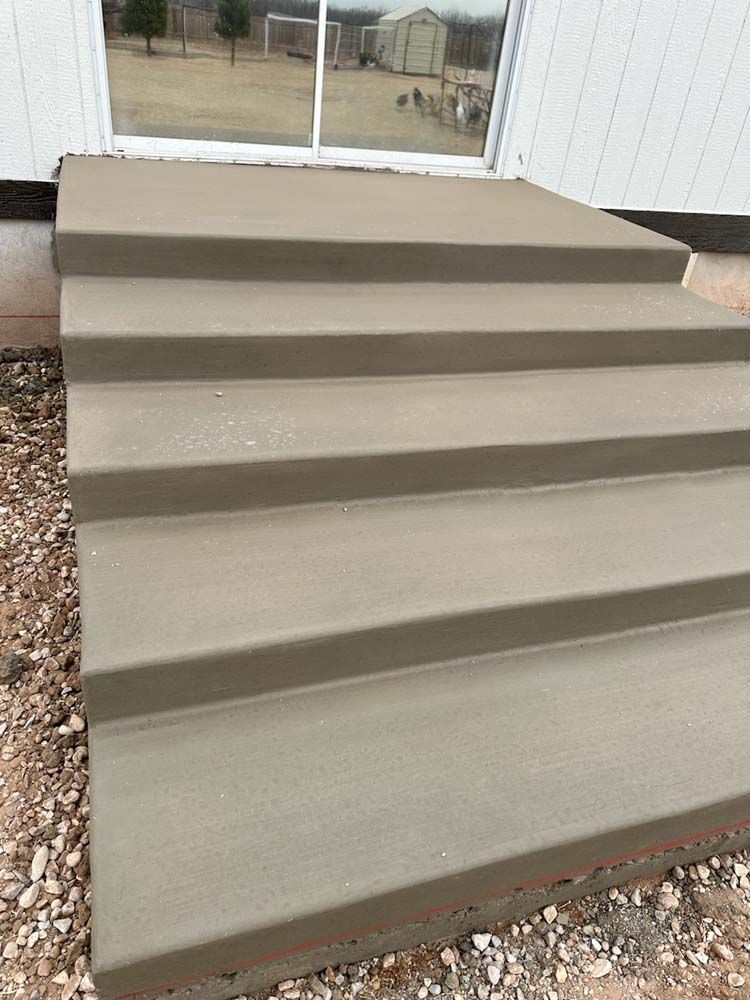 A set of concrete steps leading up to a house.