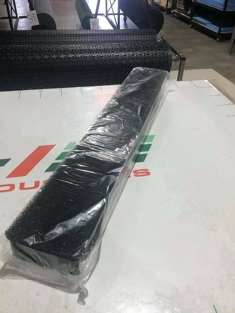 A Long Black Object is Wrapped in Plastic — F.R.I. Foam & Rubber Industries In Gympie, QLD