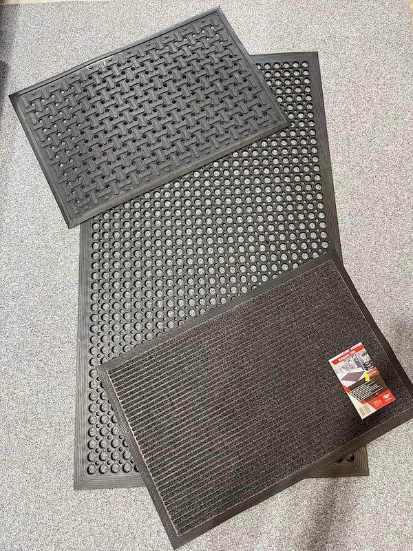 Three Black Rubber Mats Are Stacked on Top of Each Other on a Carpet — F.R.I. Foam & Rubber Industries In Buderim, QLD