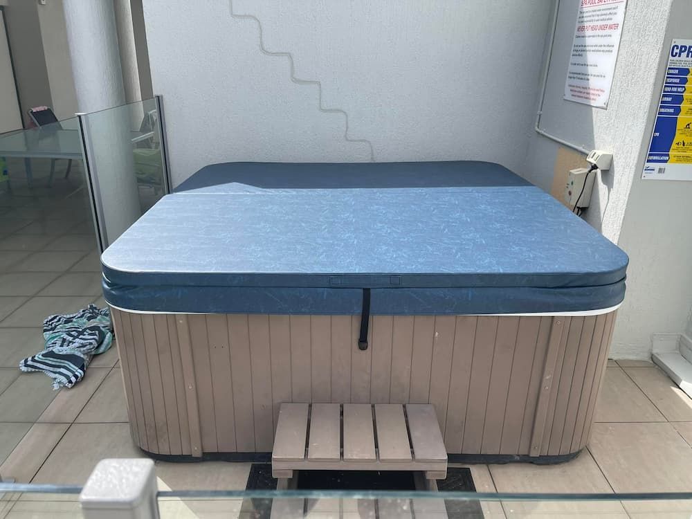 A Hot Tub With a Blue Cover and Stairs in the Background — F.R.I. Foam & Rubber Industries In Buderim, QLD