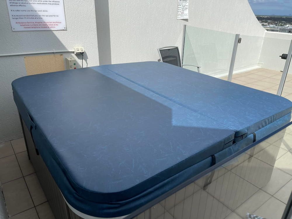 A Hot Tub With a Blue Cover is on a Balcony — F.R.I. Foam & Rubber Industries In Buderim, QLD