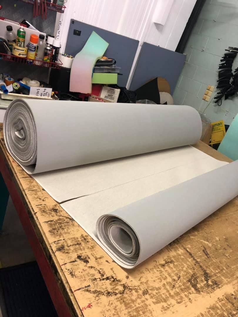 A Roll of White Paper is Sitting on a Wooden Table — F.R.I. Foam & Rubber Industries In Gympie, QLD