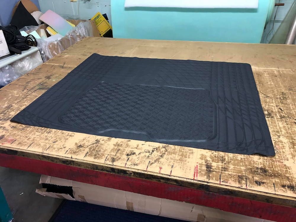A Black Mat is Sitting on Top of a Wooden Table — F.R.I. Foam & Rubber Industries In Buderim, QLD