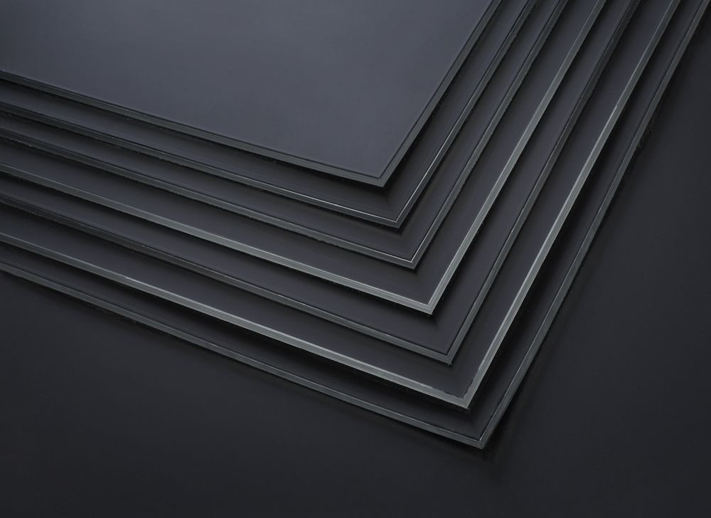 A Stack of Black Sheets of Metal Are Stacked on Top of Each Other on a Black Background — F.R.I. Foam & Rubber Industries In Buderim, QLD