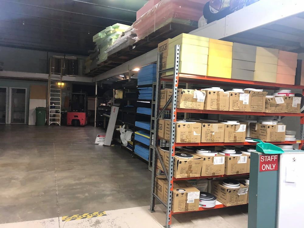 A Warehouse Filled With Lots of Boxes and Shelves — F.R.I. Foam & Rubber Industries In Buderim, QLD