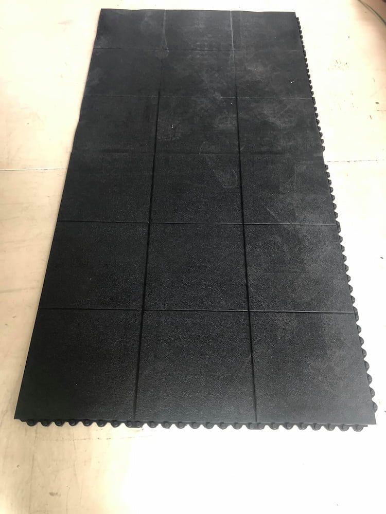 A Black Rubber Mat is Sitting on a White Floor — F.R.I. Foam & Rubber Industries In Buderim, QLD