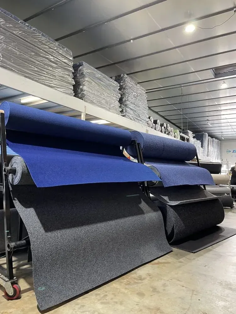 A Warehouse Filled With Rolls of Blue and Gray Carpet — F.R.I. Foam & Rubber Industries In Buderim, QLD