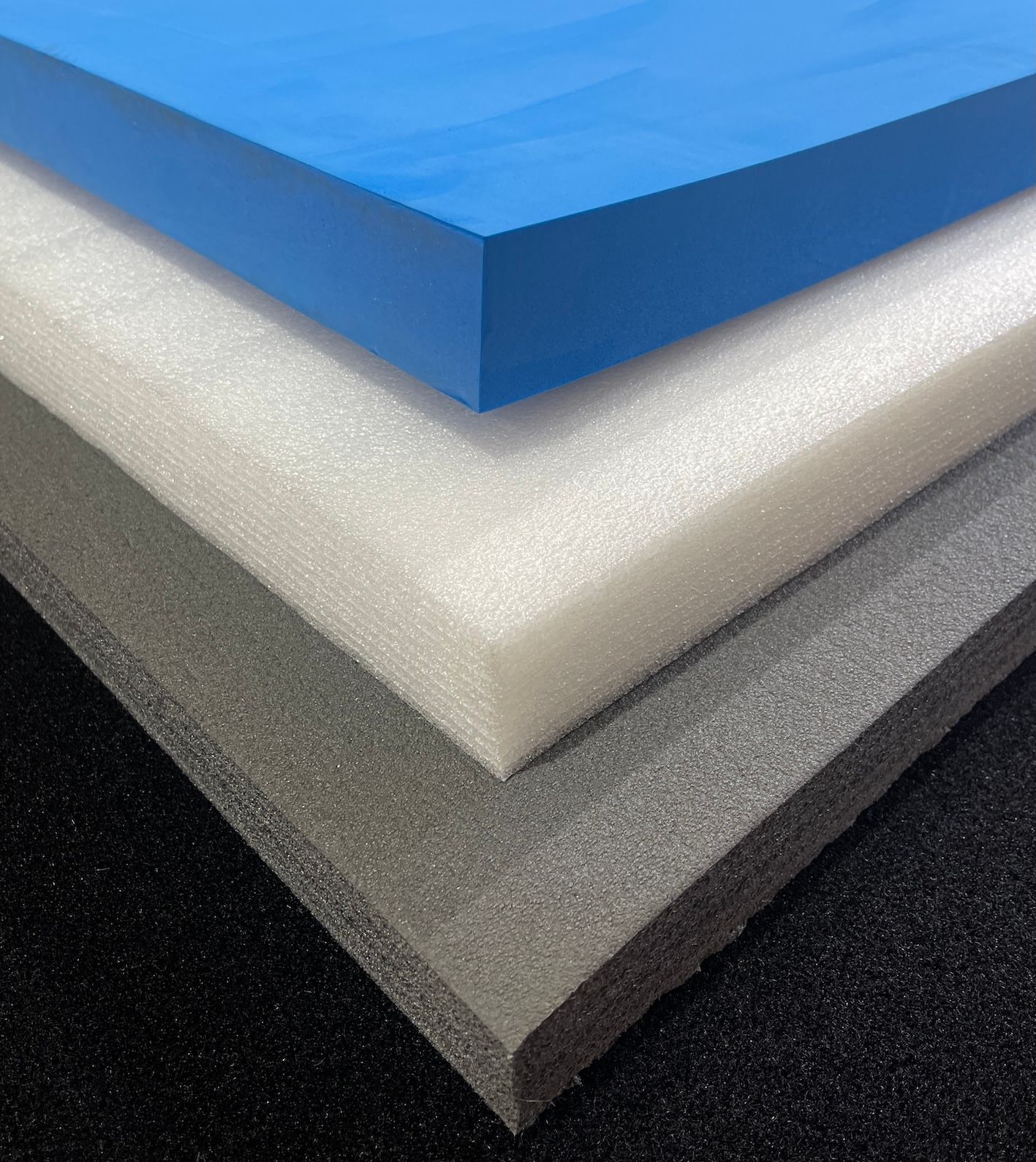 Diagonal arrangement of colorful paper in gray, white, and blue.