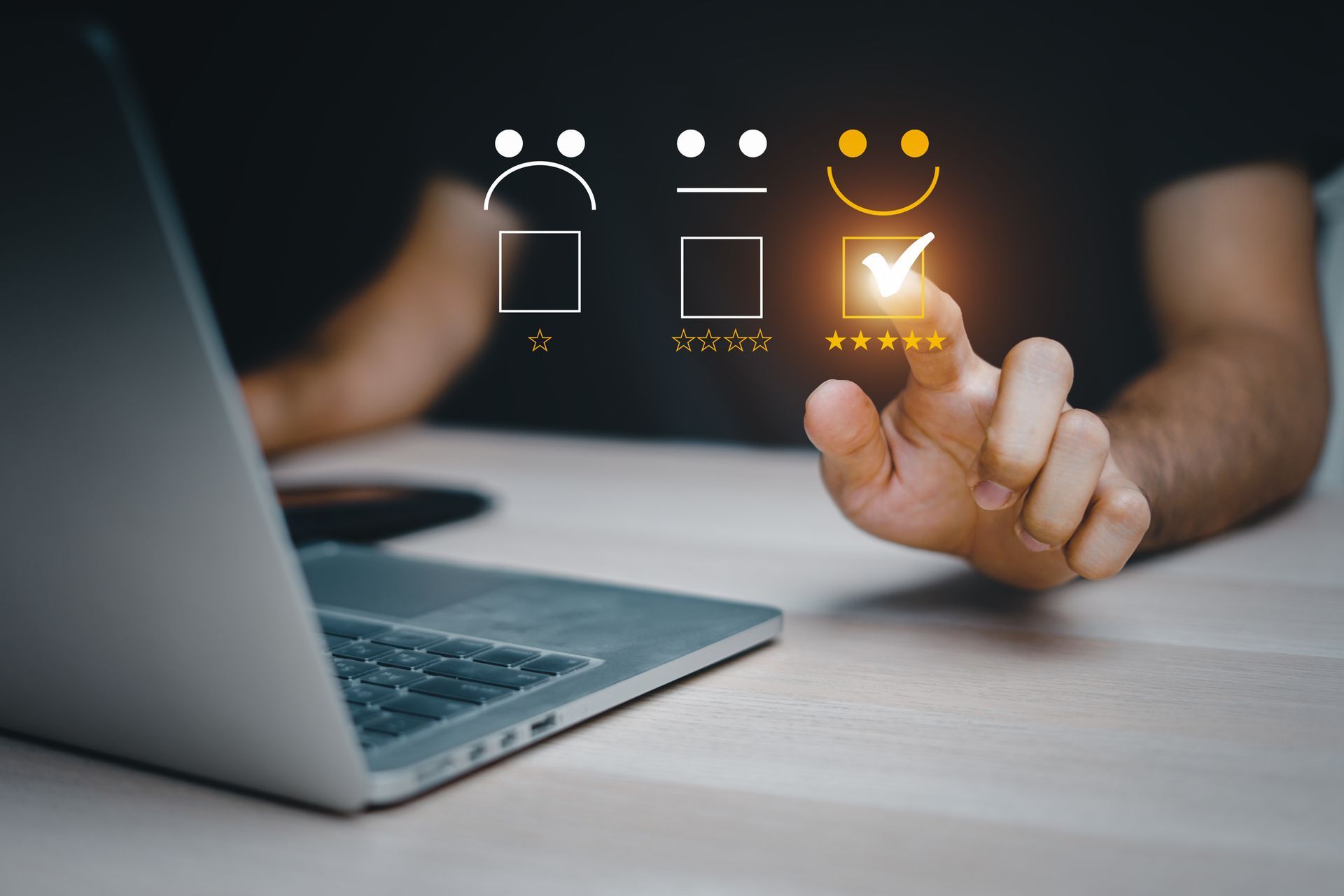 Person using a laptop, selecting a happy face with a checkmark on a customer satisfaction survey.