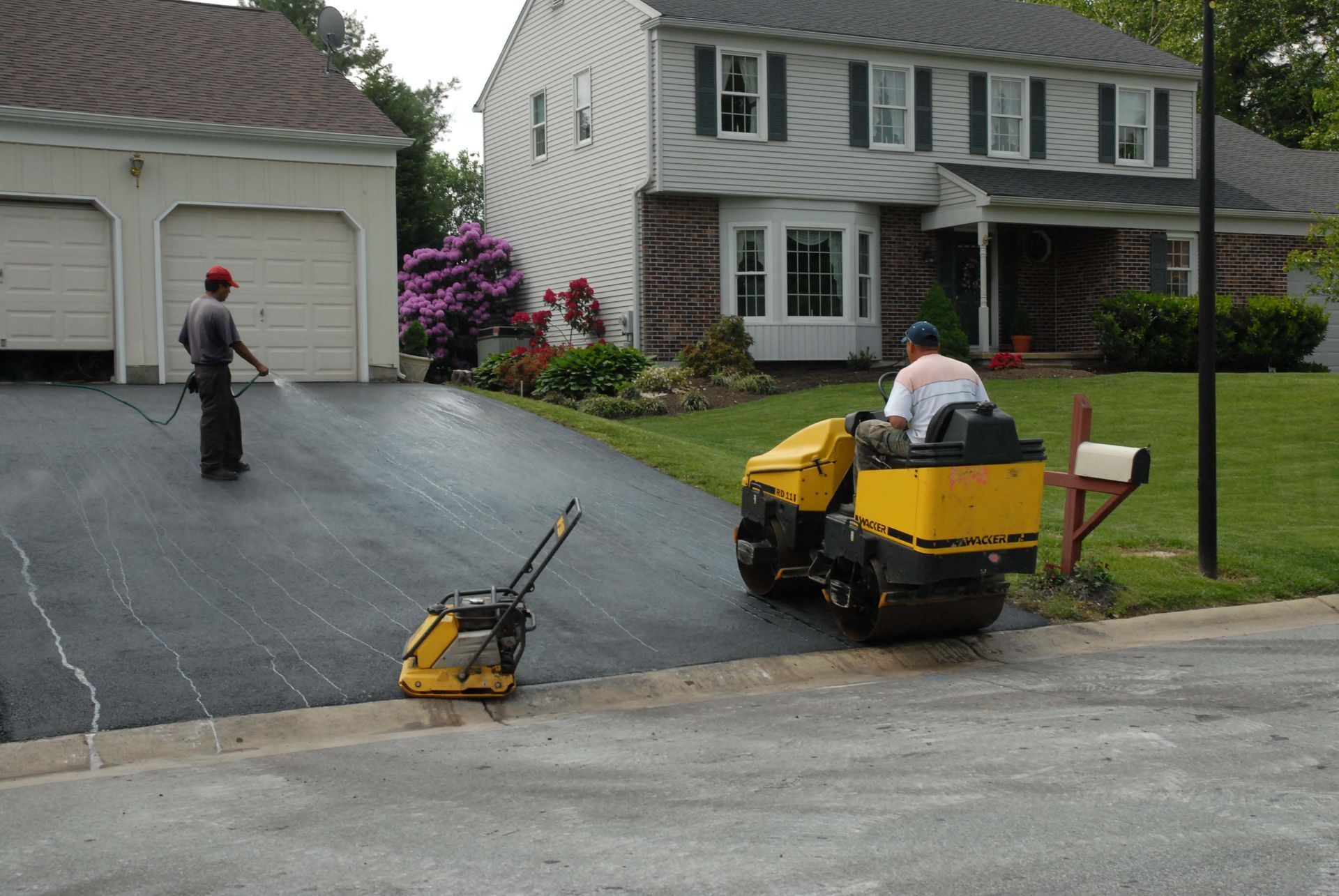 Patio with outdoor dining set, umbrella, plants, and French doors.