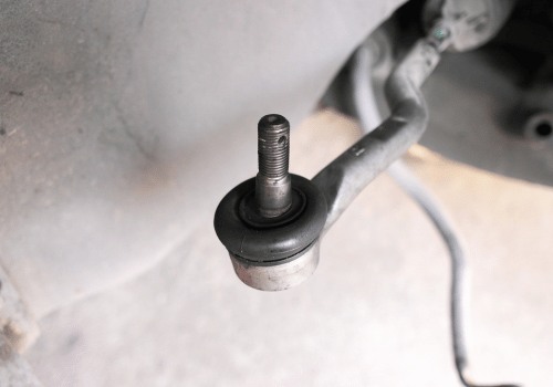 Close up of vehicle tie rod end component during steering and suspension repair