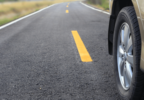 Close-up of a vehicle tire on a paved road