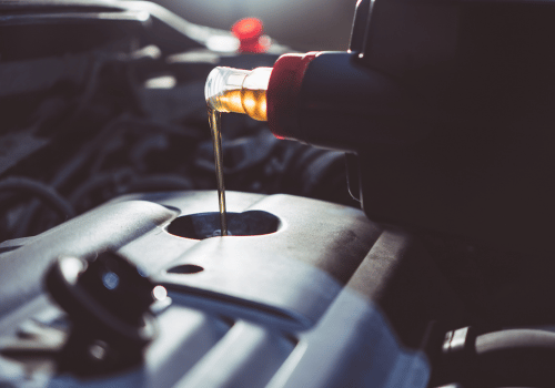 Motor oil being poured into car engine during oil change