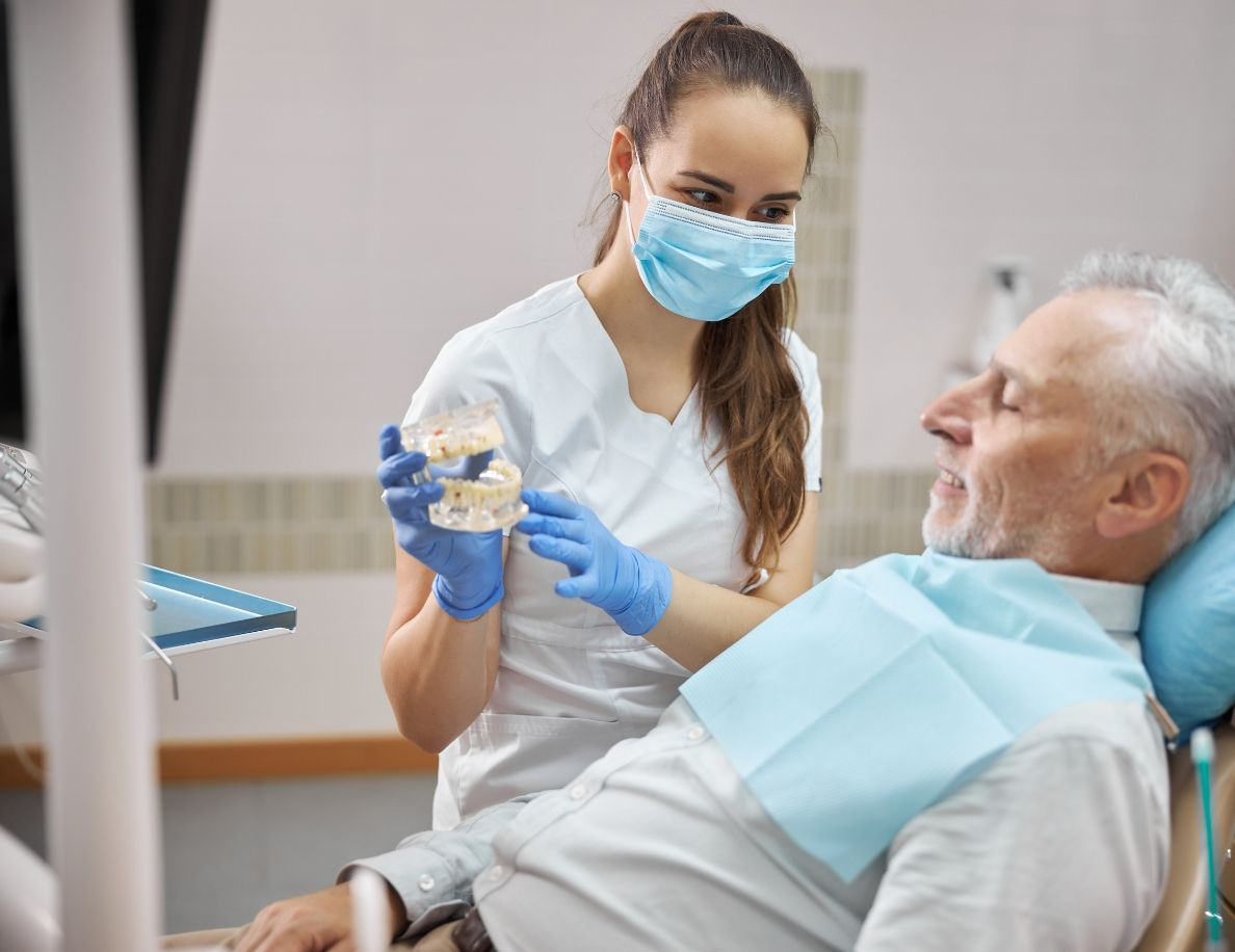 A computer generated image of a dental bridge with two dental implants.