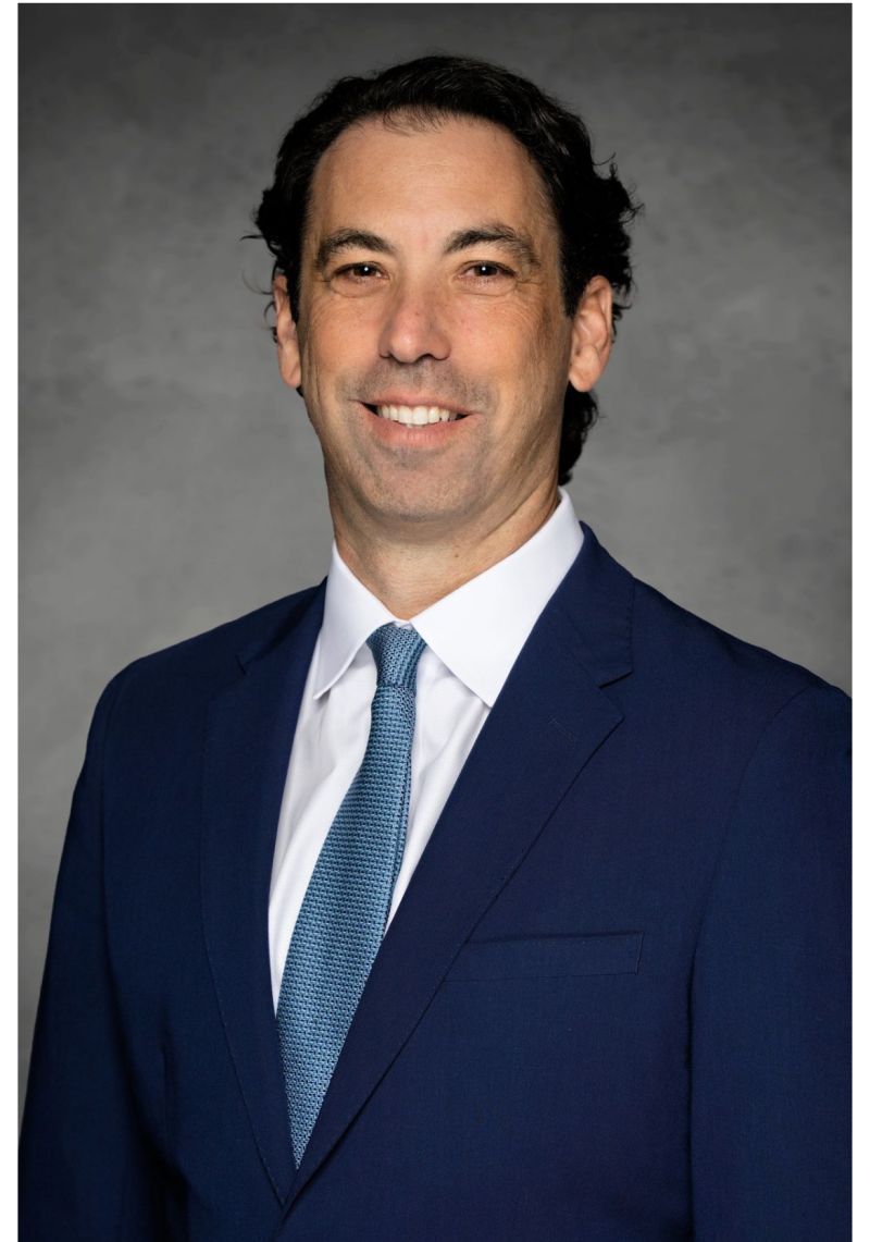 A man in a brooklyn nets jersey is holding a basketball.