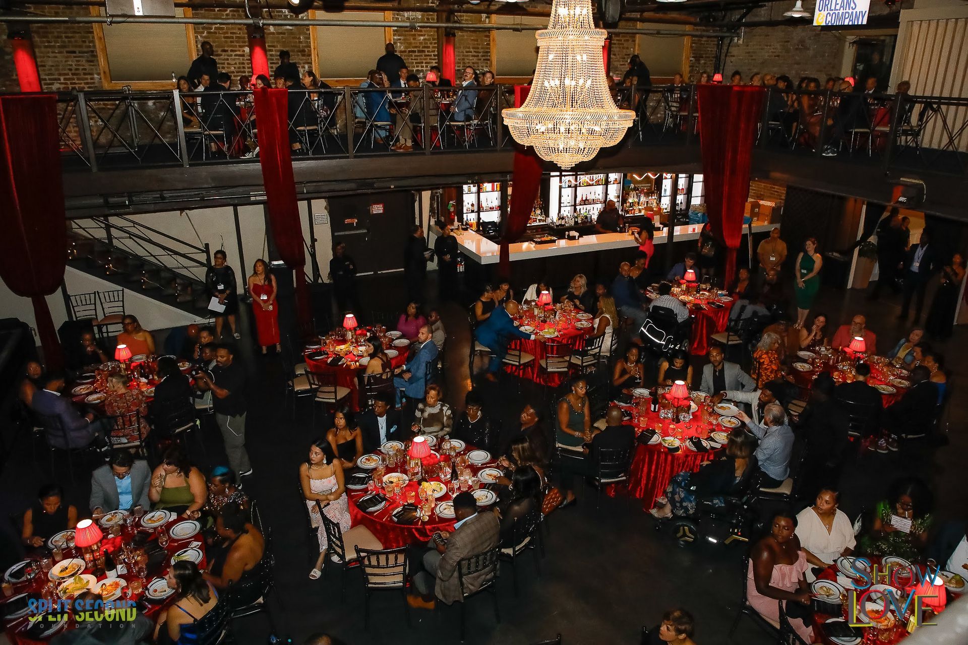 A man in a wheelchair is giving a speech in front of a large crowd.