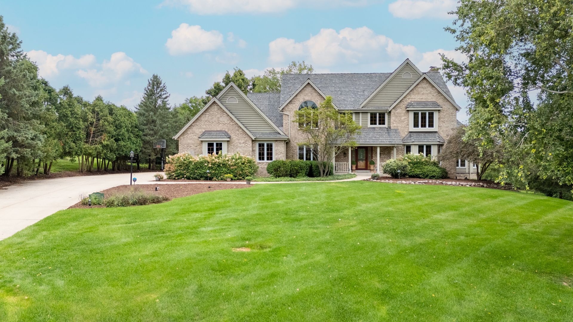 A large house with a large lawn in front of it