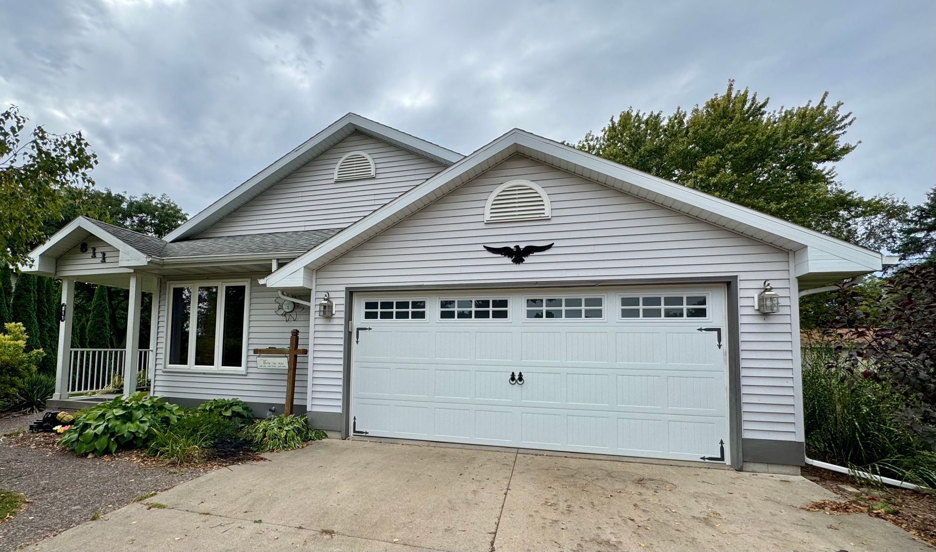 A white house with a large white garage door