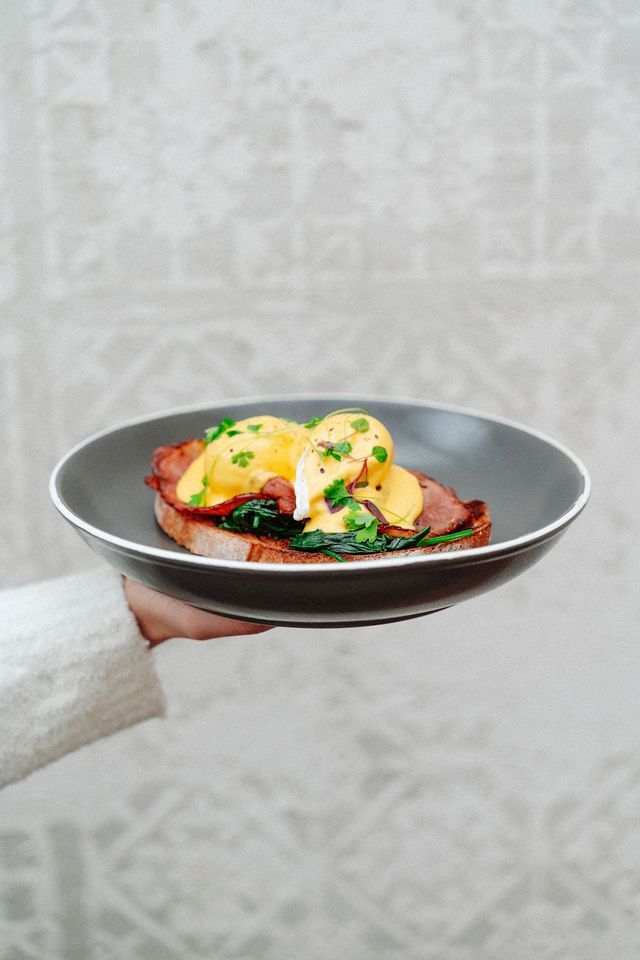 A person is holding a plate of food in their hand.