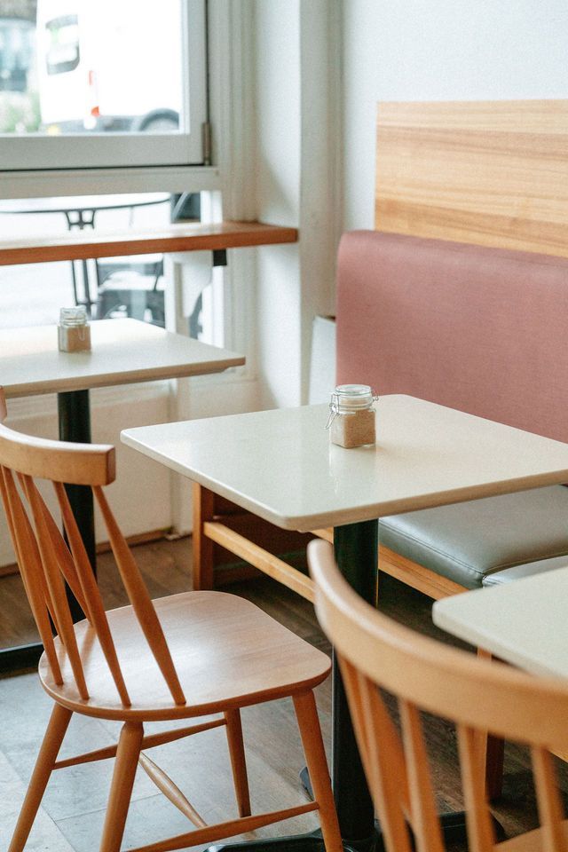 A restaurant with tables and chairs and a window.
