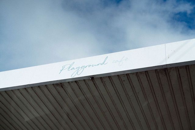 The roof of a building with the word playground written on it.