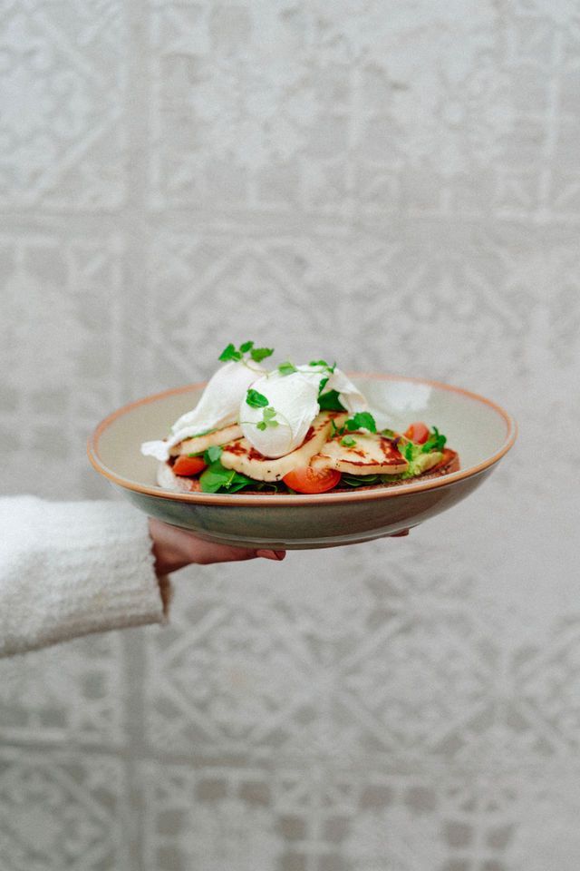 A person is holding a plate of food in their hand.