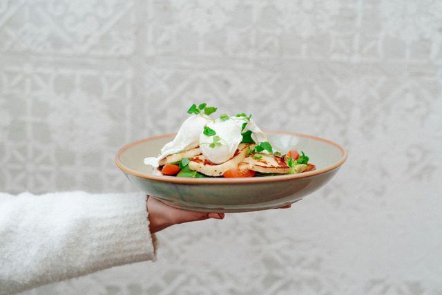 A person is holding a plate of food in their hand.