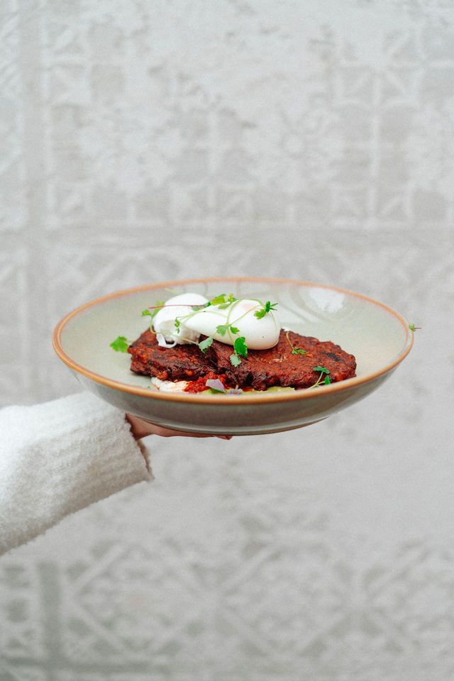 A person is holding a plate of food in their hand.