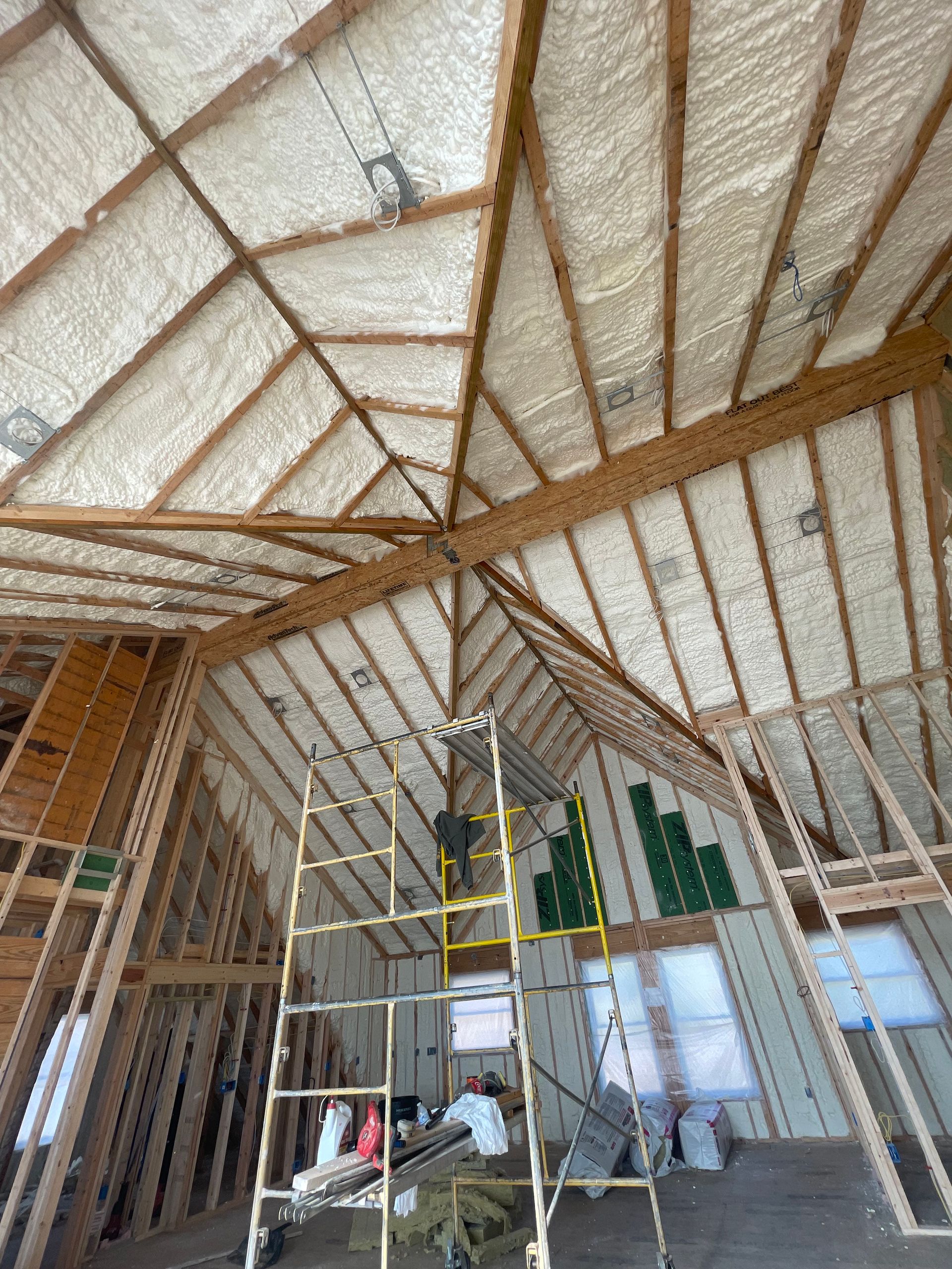 A large room with a ladder in the middle of it.
