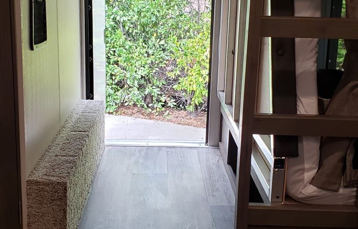 a bunk bed is sitting in a hallway next to a door .