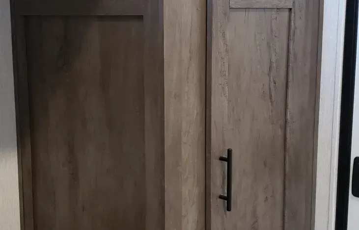 Two wooden cabinets are sitting next to each other in a room.
