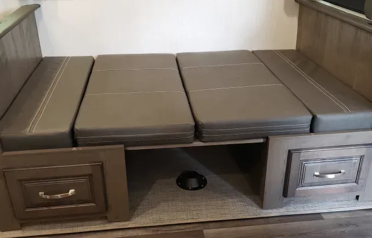 a couch that is turned into a bed in a rv .