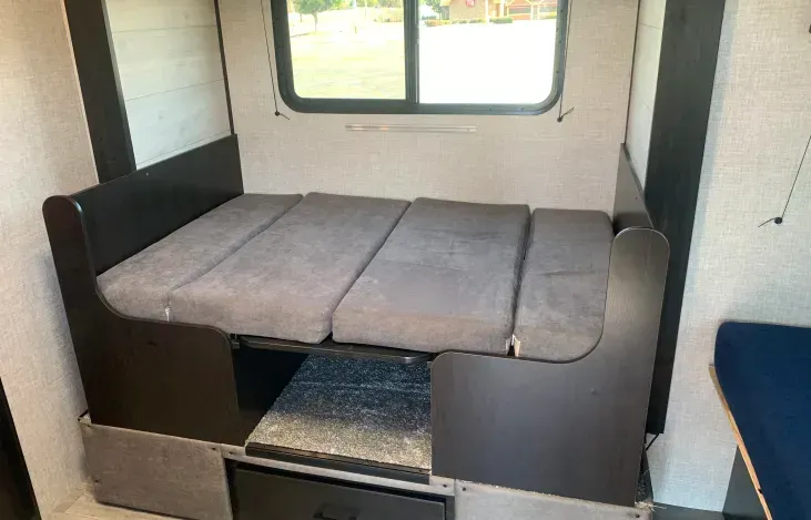 There is a bed in the back of a rv.