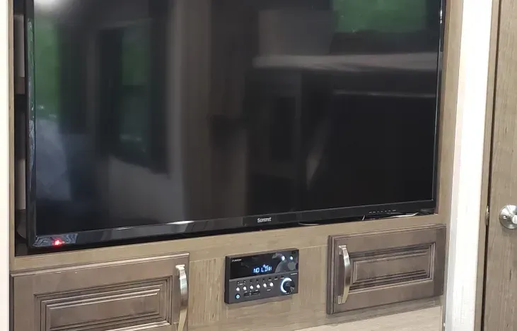 a flat screen tv is mounted on a wall in a room .